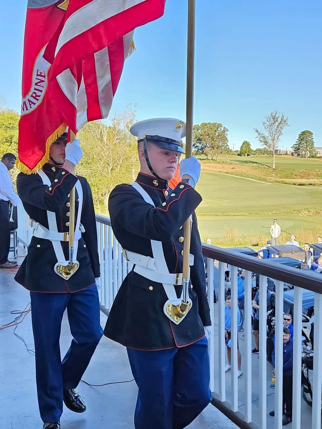An honor guard member standing at attention in dress uniform