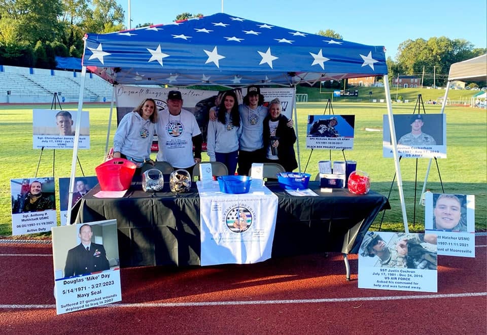 The Let's Talk Strength tent and resource table at a community event