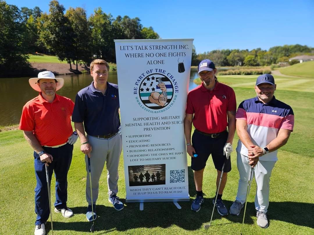 Golfers posing with the Let's Talk Strength banner at a fundraising outing