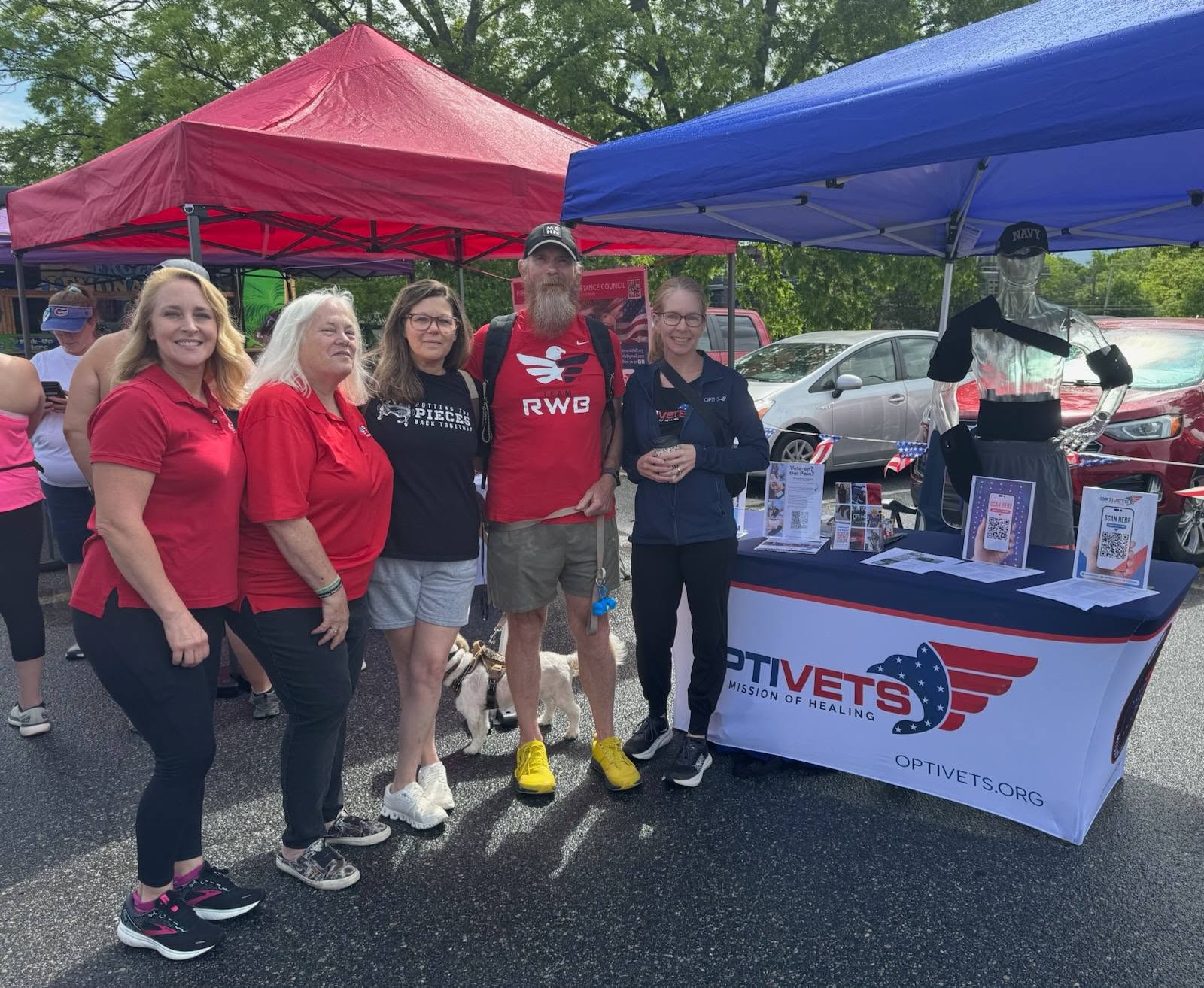 Volunteers staffing a partner resource table at a community event