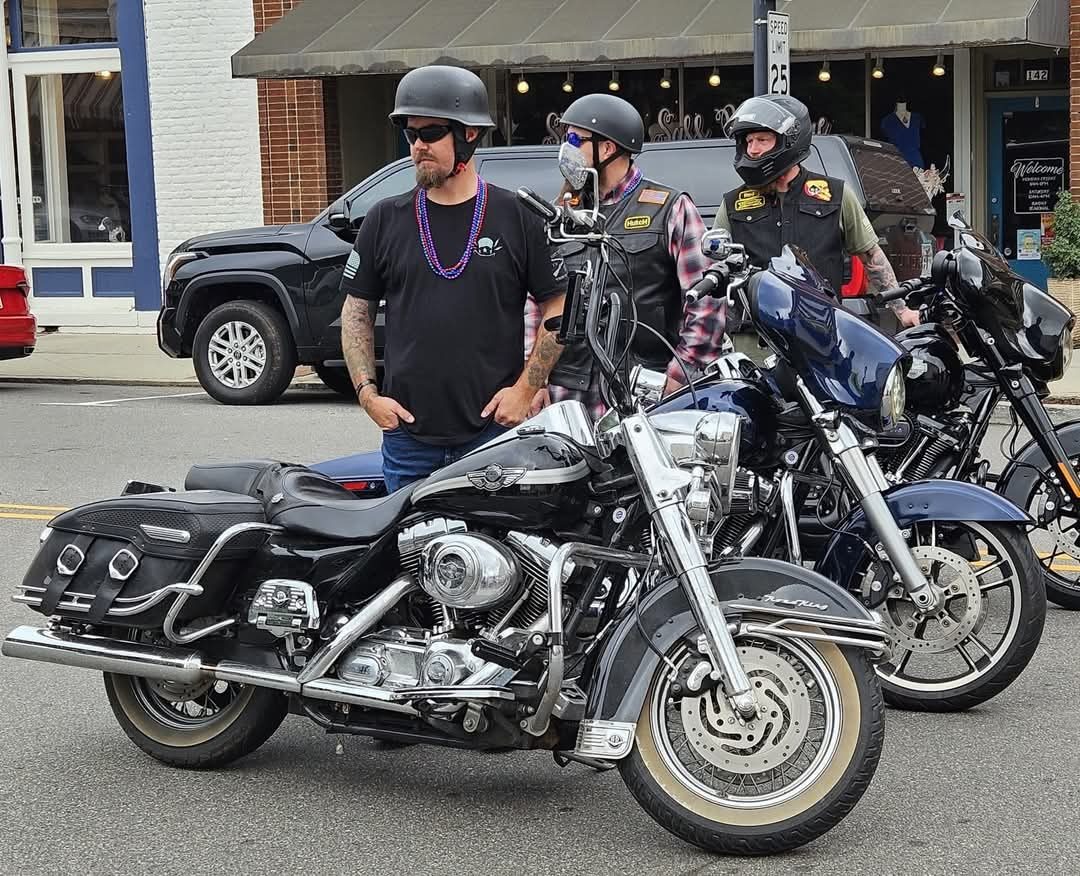 Motorcycle riders supporting a Let's Talk Strength charity ride through downtown