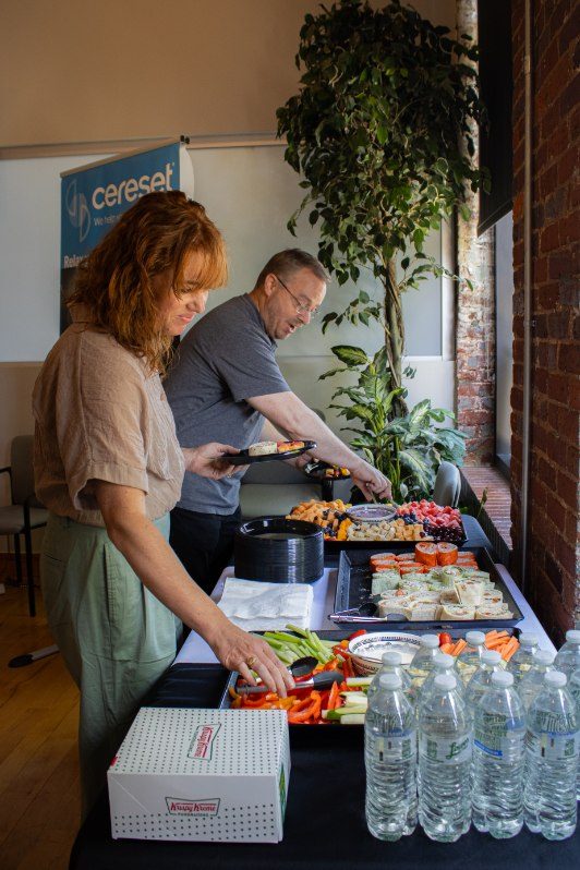 Volunteers preparing food for guests at a Let's Talk Strength reception
