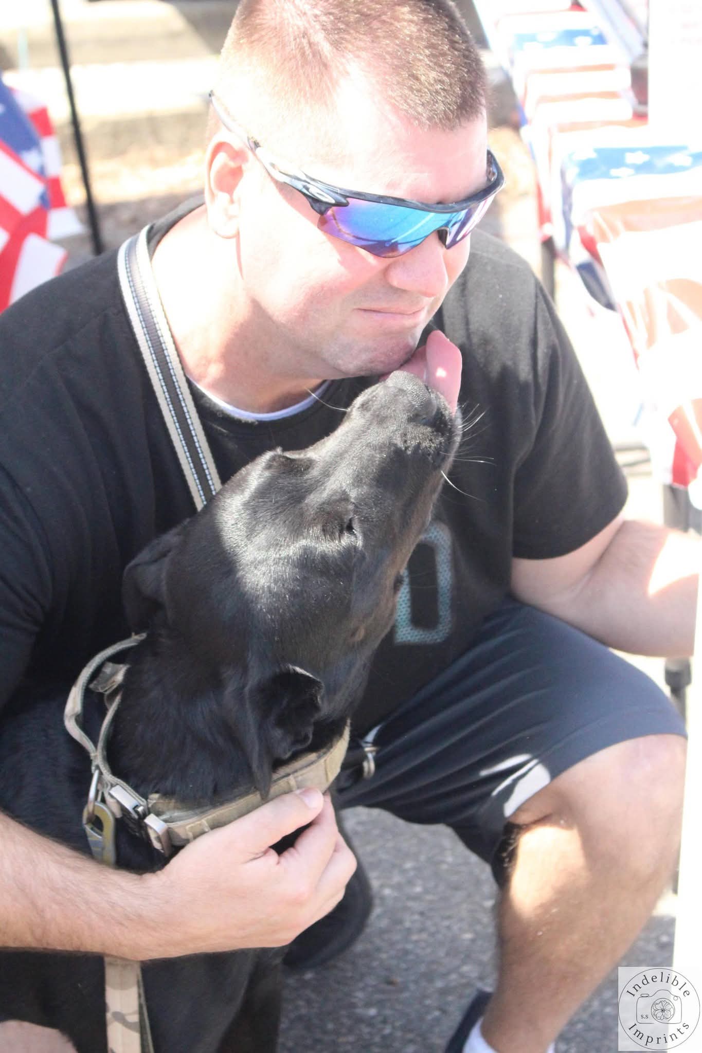 A veteran sharing a tender moment with his service dog