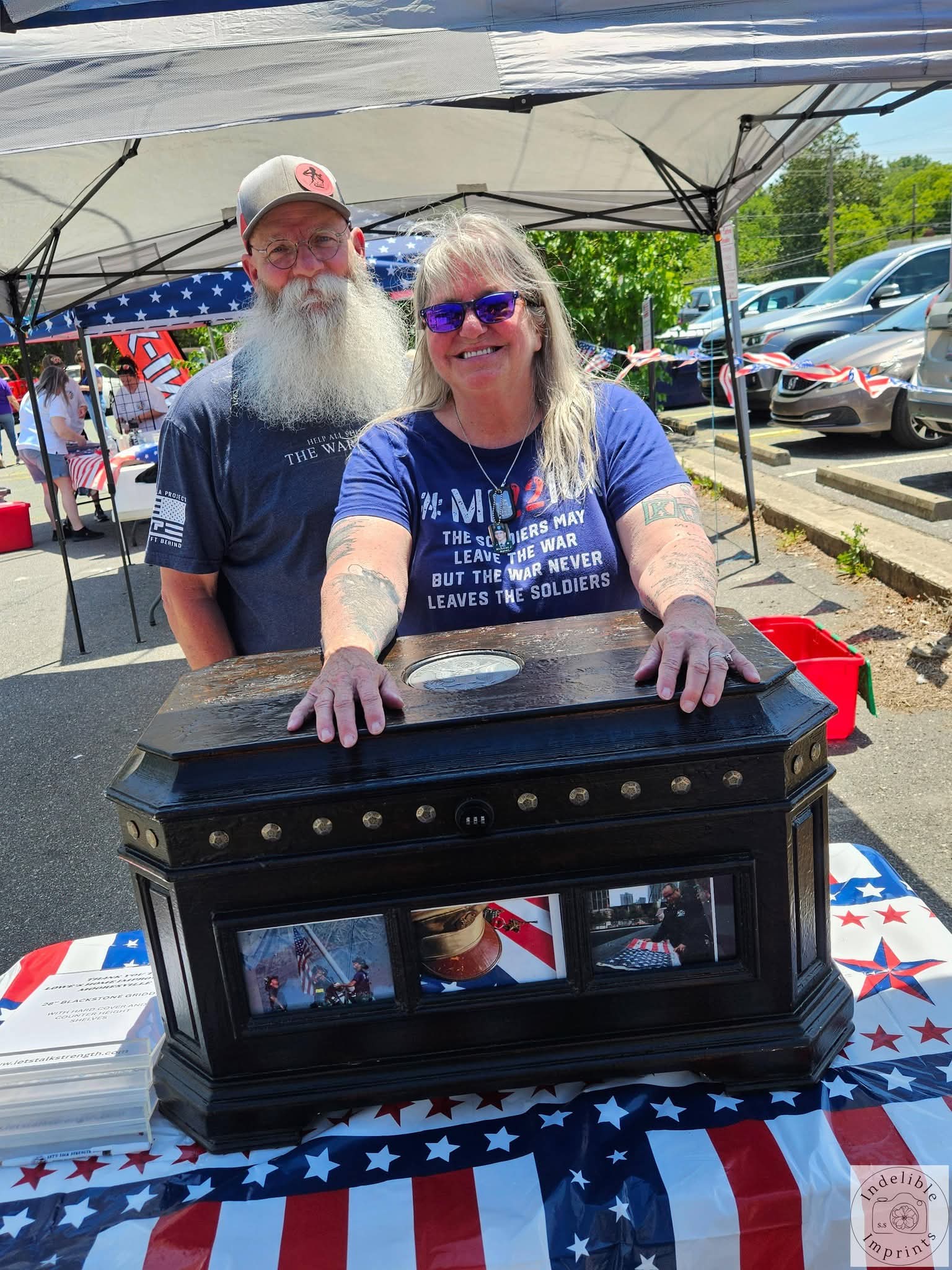 Supporters standing behind a memorial chest honoring fallen service members