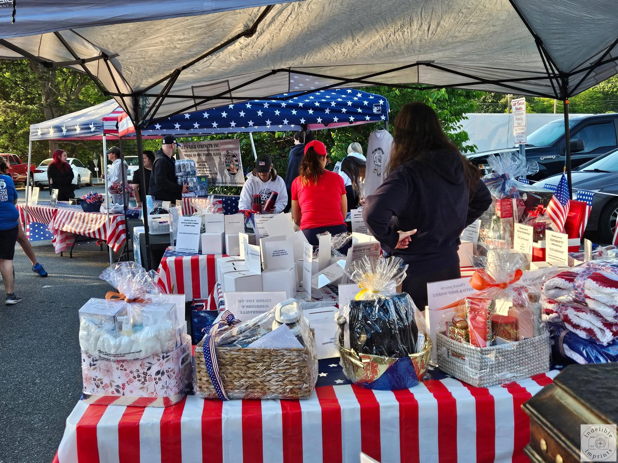 A Let's Talk Strength raffle and merchandise tent at a community event