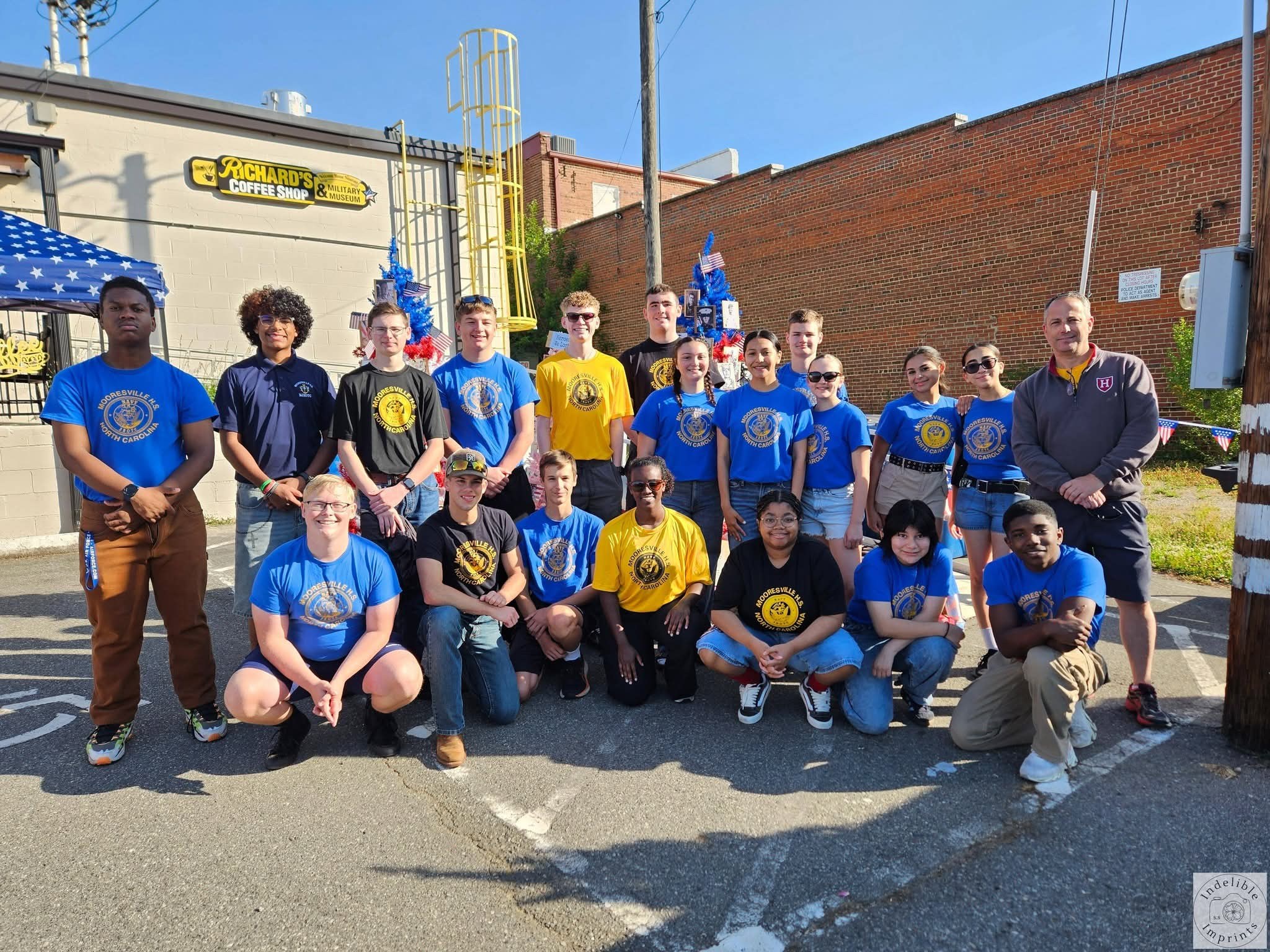 Mooresville H.S. Navy JROTC students and their coach outside Richard's Coffee Shop & Military Museum