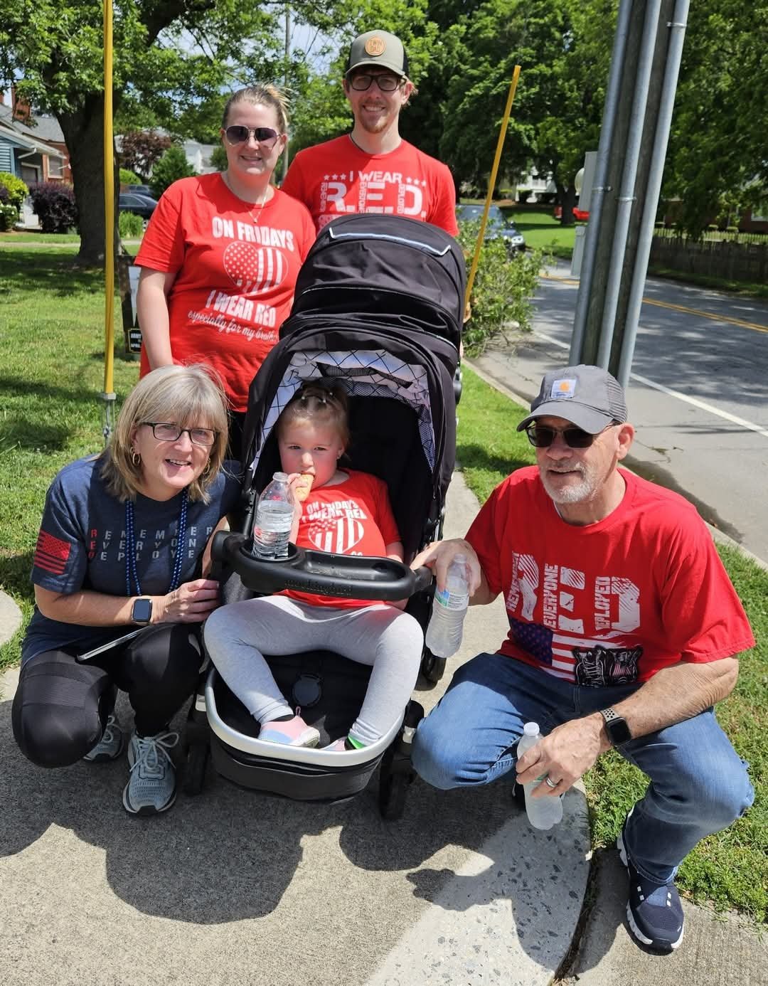 A woman holding a bag of resources from a Let's Talk Strength outreach table